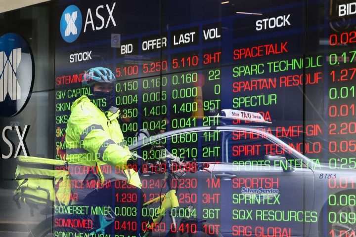 Digital stock ticker outside the ASX building, reflecting year-end market shifts and mining sector pullback.