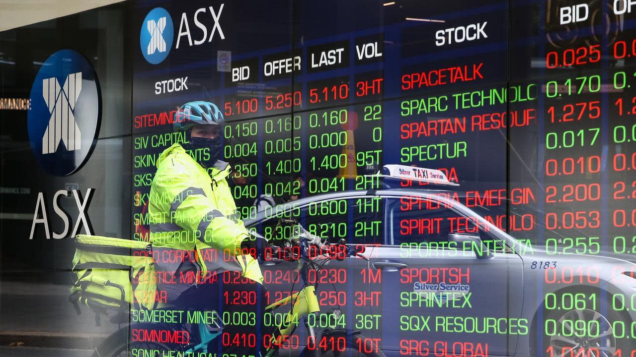 Digital stock ticker outside the ASX building, reflecting year-end market shifts and mining sector pullback.