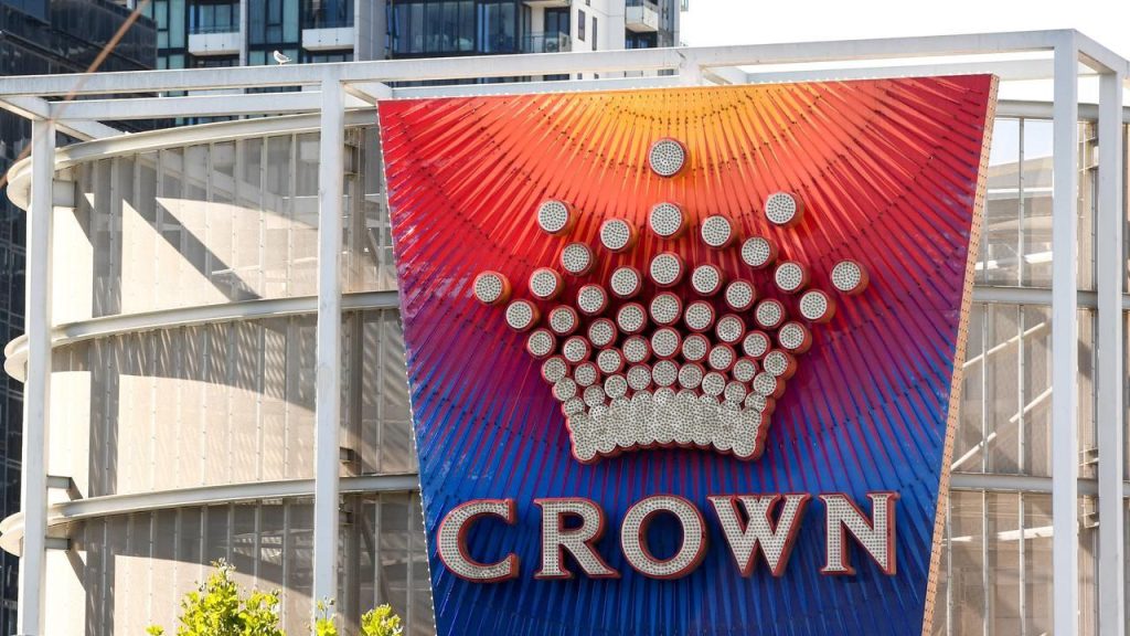 Crown Casino sign glowing at night, symbolizing the high-stakes setting of a New Year’s Eve worker strike.